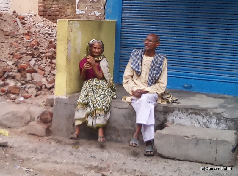 At Gaya, Elderly woman having hookah on the streets of Gaya by Gautam Lahiri