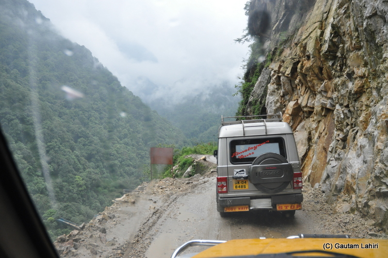 Mangan approaching with jagged mountain sections on the right and a 1000 feet drop on the left. I maintained balance of speed and brakes to avoid a skid by gautam lahiri