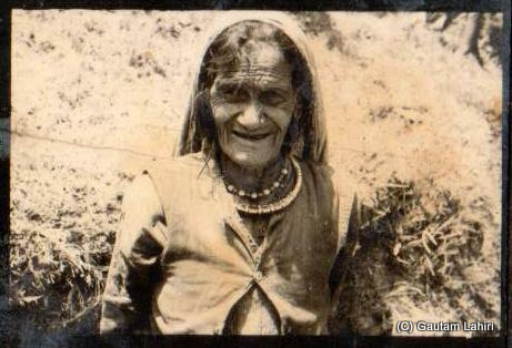 An old mountain lady, from the hills of Kumaon and Garhwal Himalayas, looks on at the geologists who were always found clinging to the hills and rocks for sample collection by Gautam Lahiri