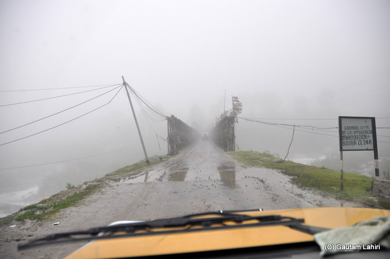 We crossed this bridge before Mangan, draped in fog and rain. Cross-winds were slamming it making it sway at Mangan, Sikkim by gautam lahiri