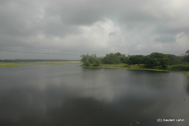 We stopped over a bridge on the Jalangi river to catch the reflection of the sky at Krishnanagar, West Bengal, India by Gautam Lahiri