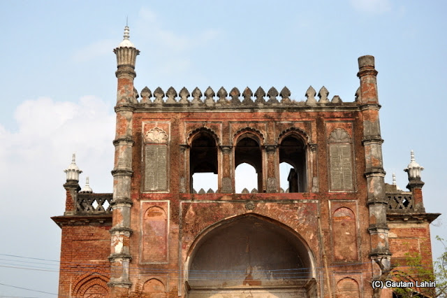 The west entrance edifice facing the sun looked darkened red with its mortar and brickwork peeling away..as we left the palace, structure in grave disrepair certainly needs looking after at Krishnanagar, West Bengal, India by Gautam Lahiri