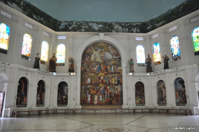 Large painting at the center of the hall with light filtering through the colored glasses made us feel as if the painting change as if walked from one side to the other at Krishnanagar, West Bengal, India by Gautam Lahiri