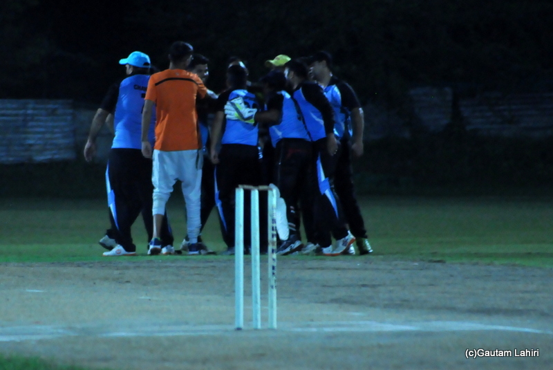 Cricket fielders jump with joy as a wicket falls by Gautam Lahiri