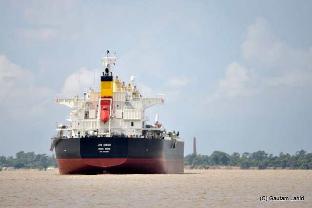 A large oil tanker cuts through the river Ganges at Diamond Harbor, West Bengal, India by Gautam Lahiri
