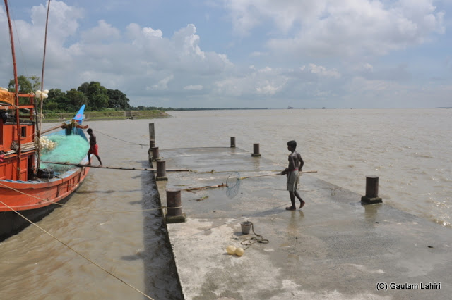 A large fishing boat sets off from the banks of river Ganges at Diamond Harbor, West Bengal, India by Gautam Lahiri