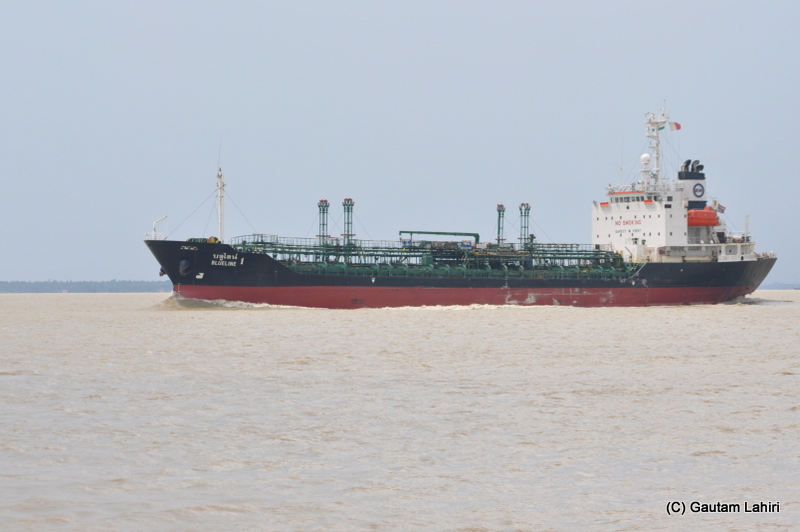 A large oil tanker cuts through the river Ganges at Diamond Harbor, West Bengal, India by Gautam Lahiri