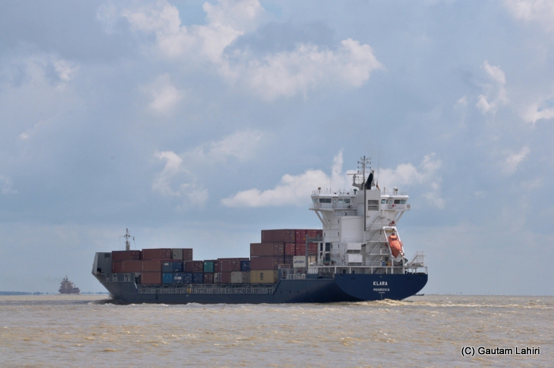 A large container ship cuts through the river Ganges at Diamond Harbor, West Bengal, India by Gautam Lahiri