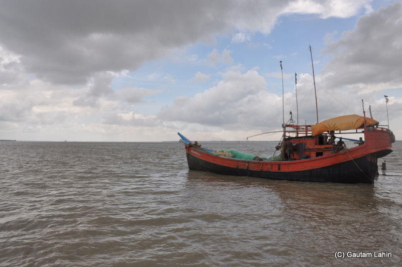 A large fishing boat sets off from the banks of river Ganges at Diamond Harbor, West Bengal, India by Gautam Lahiri