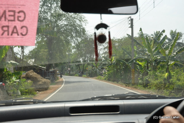 We followed the carpeted road of asphalt with swaying banana trees on the road edge with the big leaves welcoming us to the riverfront  at Gadiara road from NH2 in Hooghly, West Bengal, India by Gautam Lahiri