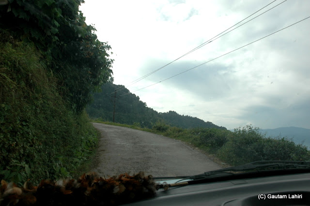 Hillside driving.. which one to see, the beautiful scenery around you through the windows or the road ahead  at Darjeeling, West Bengal, India by Gautam Lahiri