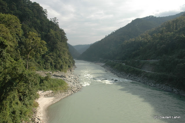 Crossing the Teesta river and stopping to take a break to see the fast-moving river water splashing against the rocks that shoulder the banks  at Darjeeling, West Bengal, India by Gautam Lahiri