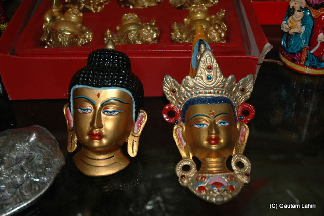Buddha heads, with intricate designs on display  at Darjeeling, West Bengal, India by Gautam Lahiri