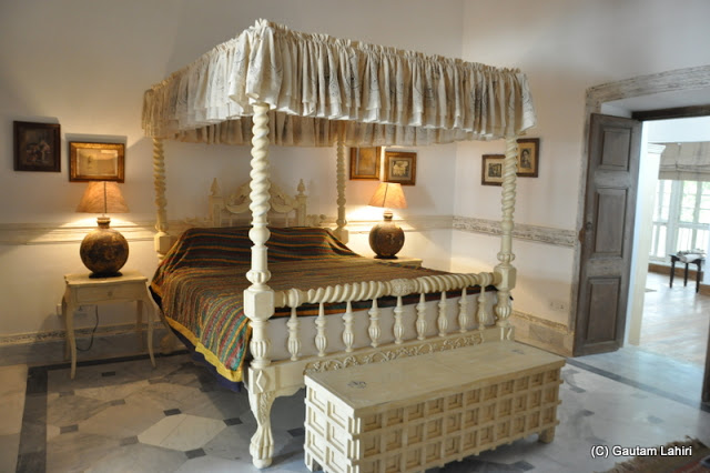 An upmarket room with off-white colored surroundings is sure to give a visitor a night right out of the early 1900s' at Bawali Rajbari, Kolkata, West Bengal, India by Gautam Lahiri