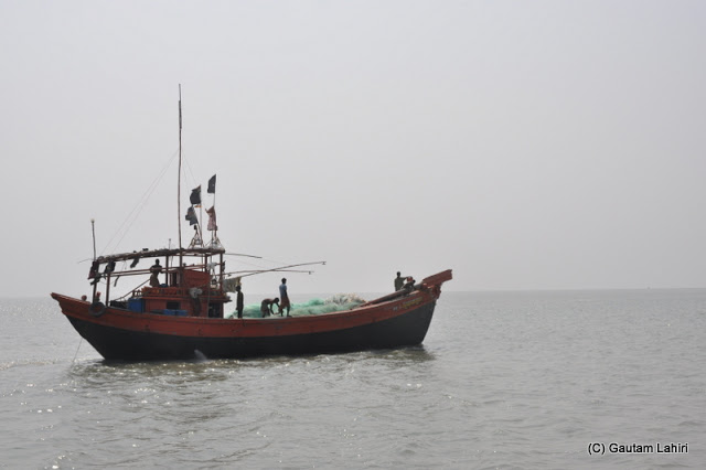 Fishing boat in Bay of Bengal at Frasergunj, Bakkhali beach, West Bengal, India near Bay of Bengal by Gautam Lahiri