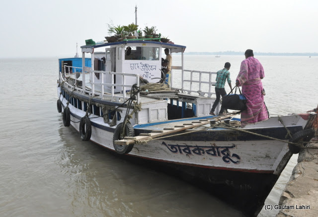 Passengers over the deck making their way into the sitting compartment on Rupnarayan river at Gadiara, Hooghly, West Bengal, India by Gautam Lahiri