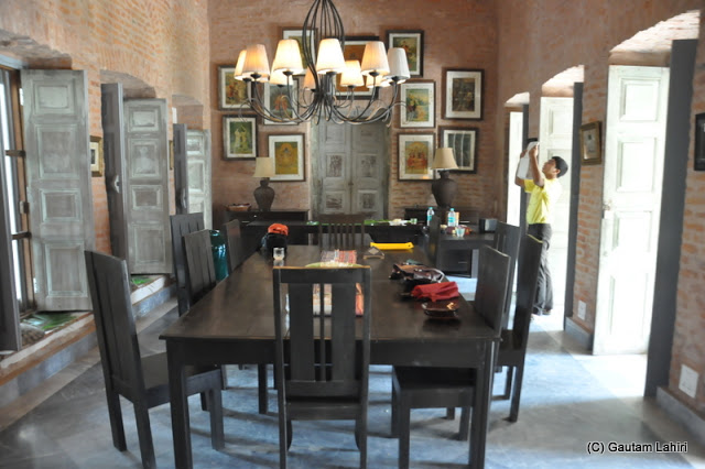 A wide and long dinner table at the center of the room with the air condition vents above made us quite comfortable at Bawali Rajbari, Kolkata, West Bengal, India by Gautam Lahiri
