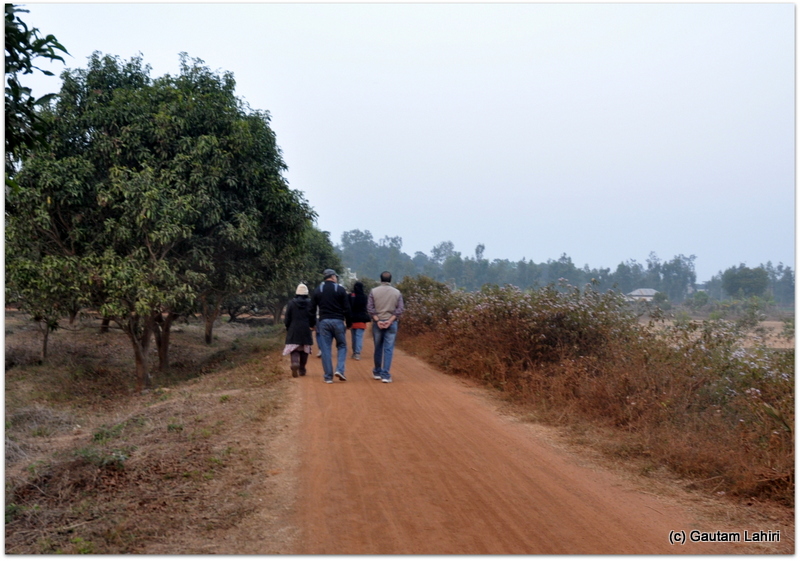 The group trudging over the red soil as I reared up to catch few glimpses of the colorful scenery at Joypur forest, Bankura by Gautam Lahiri