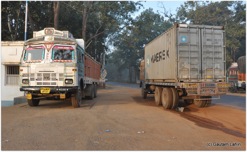 A couple of trucks parked on the road to catch some refreshments after their night long drives. Exchanging niceties, we made our way through them to the forest beyond at Joypur forest, Bankura by Gautam Lahiri