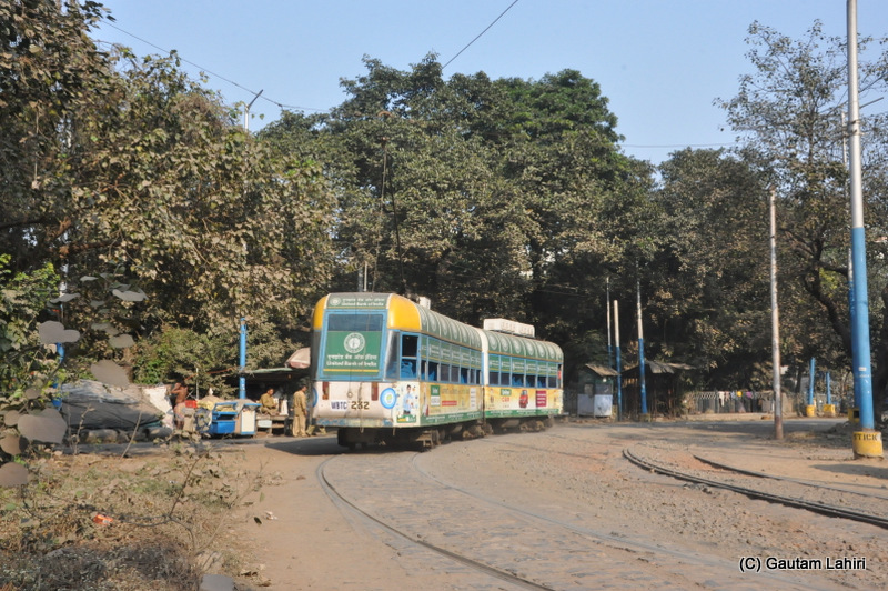A Calcutta Tramways decorated two compartments tram parked at Esplanade tram terminus, Kolkata, West Bengal, India by Gautam Lahiri