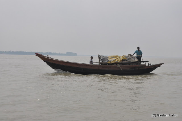 Fishermen returning with their morning catch on Rupnarayan river at Gadiara, Hooghly, West Bengal, India by Gautam Lahiri