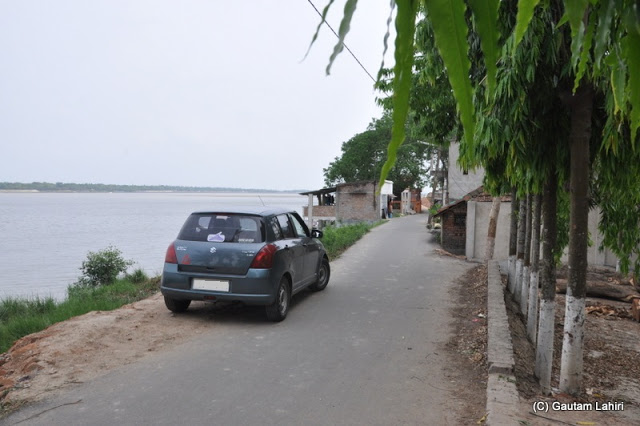 We parked almost at the edge of the land mass where the river started to keep enough room for another car to pass at Taki, West Bengal, India by Gautam Lahiri
