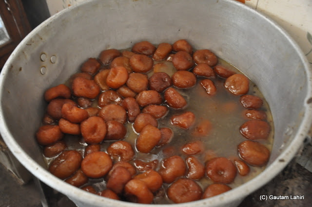 Chanar Malpoa fried first and then dipped in its sugary syrup and I loved them when they were hot at Taki, West Bengal, India by Gautam Lahiri 