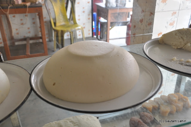 Chanar malpoa in paste form. It has taken the shape of its container. Very yummy.. at Taki, West Bengal, India by Gautam Lahiri