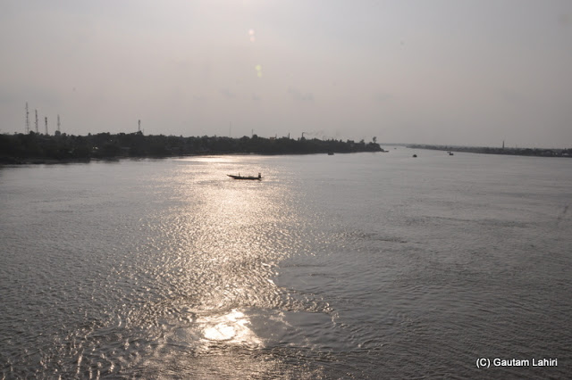 Crossing the Vidyadhari river which was glistening in the setting sun as we returned from Taki, West Bengal, India by Gautam Lahiri