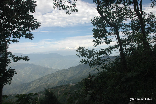 As the day grew older, the clouds thickened, slowly blanking Khangchendzonga as we saw the range through the forest  at Darjeeling, West Bengal, India by Gautam Lahiri