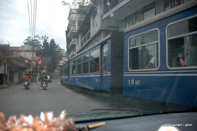 The Darjeeling toy train and our car playing hide and seek on the Hill Cart Road  at Darjeeling, West Bengal, India by Gautam Lahiri