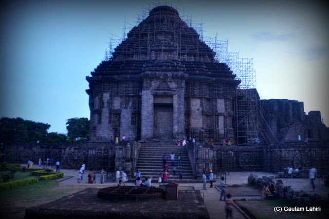 Konark temple silhouettes against the evening sky as the sun flashes its rays to the Surya god adorning the temple on its western fringe and vanishes into the horizon  at Puri, Odisha, India by Gautam Lahiri