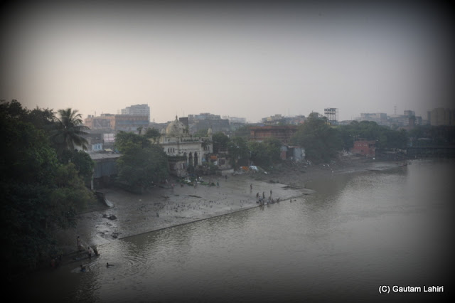 The muddy bank and the river water sweeping over the temples which are standing in unison for not less than 200 years  at Kolkata, West Bengal, India by Gautam Lahiri