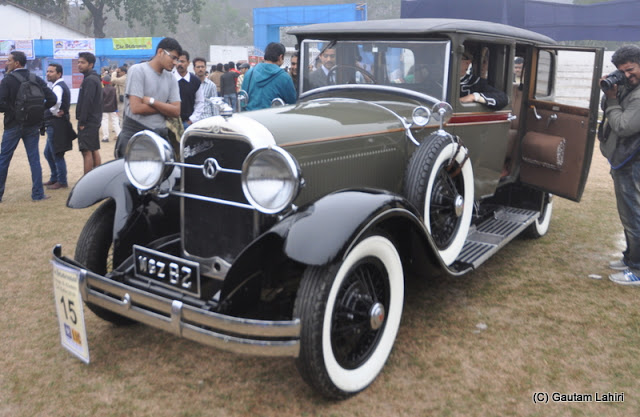 Onlookers are mesmerized by the beauty of this 1928 Studebaker  at Kolkata, West Bengal, India by Gautam Lahiri