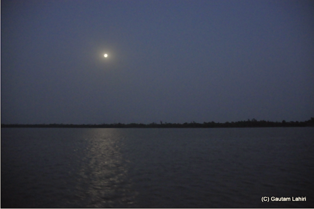 Moon shines brightly over the river, making the reflection shimmer like thousand crystals as our house boat makes her way through the river 