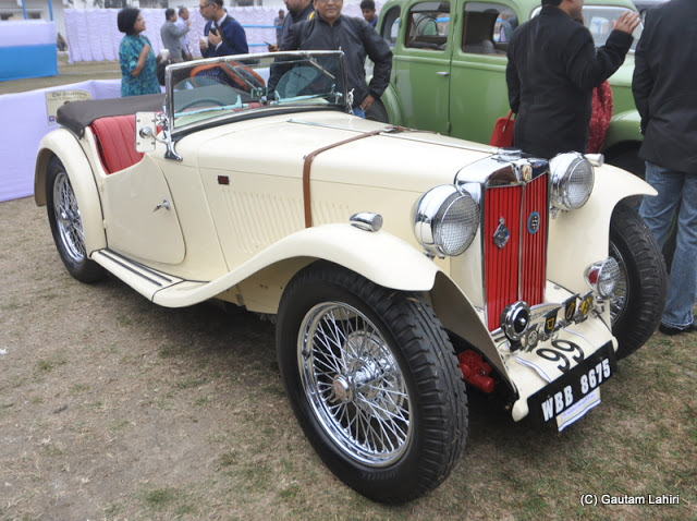 An off-white 1948 Midget, small British two-seater attracted considerable crowd with her neat and compact design  at Kolkata, West Bengal, India by Gautam Lahiri