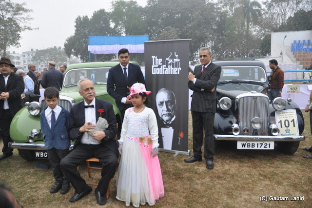 A 1948 Rover, 14 HP, 4 cylinders vintage surrounded lovingly by her owner family..the elderly poses as The Godfather  at Kolkata, West Bengal, India by Gautam Lahiri