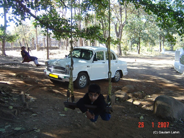 Swinging away with the wafting crisp breeze as the Ambassador too takes a break with us from Nagpur to Kanha forest reserve by Gautam Lahiri