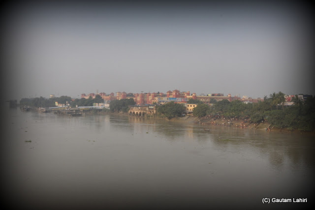 Howrah station over the horizon where the river meets her washed bank  at Kolkata, West Bengal, India by Gautam Lahiri