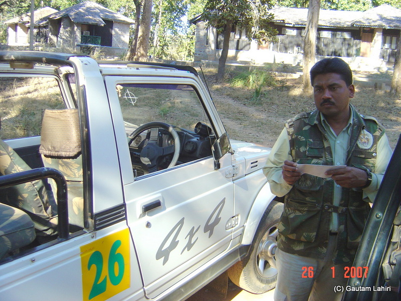 Alim, the Gypsy driver checking our papers before we climbed the vehicle at Kanha forest by Gautam Lahiri