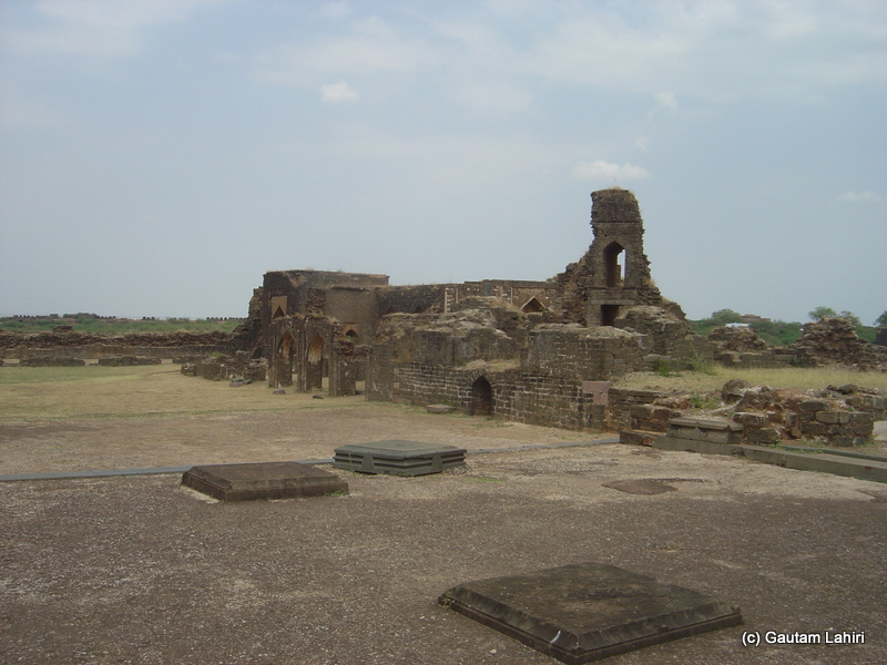 Broken stone walls, gallant archways eaten away by nature or by cannon balls lay motionless over a section of the fort at Bidar fort by Gautam Lahiri