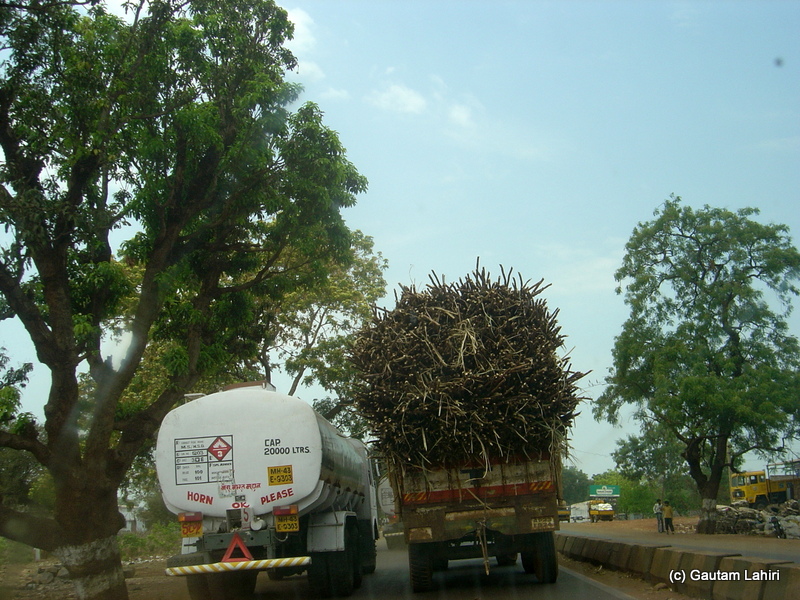 A long fuel tanker is seen overtaking from the left as it passes a trailer loaded with sugarcane. The trailer was already listing on its springs by about ten degrees. I did not dare to overtake or follow the tanker. If the sugarcane topples, we would be pasted across the carpet road in no time from Hyderabad to Bidar by Gautam Lahiri