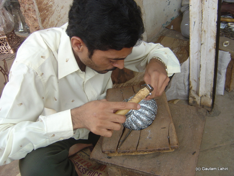 Artisans using simplest of the tools, as we see here, a light hammer and chisel to carve out metal ornamentation on Bidriware at Bidar by Gautam Lahiri