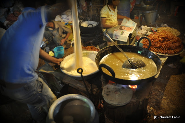 The batter mix for the jalebi at Santiniketan poush mela, West Bengal, India by Gautam Lahiri