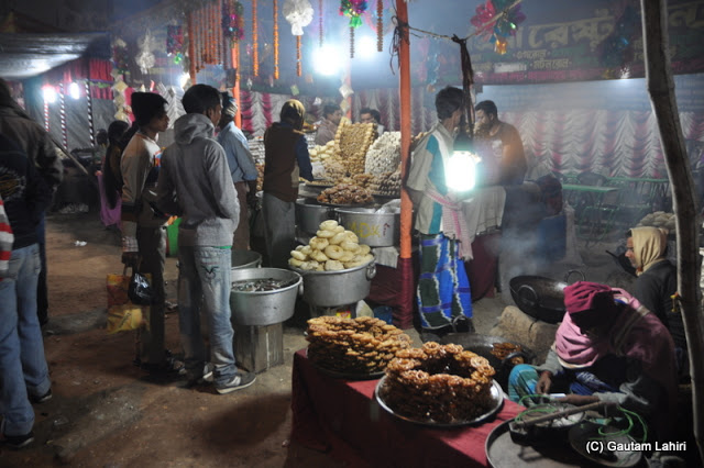 An array of fried food ready to be served at Santiniketan poush mela, West Bengal, India by Gautam Lahiri
