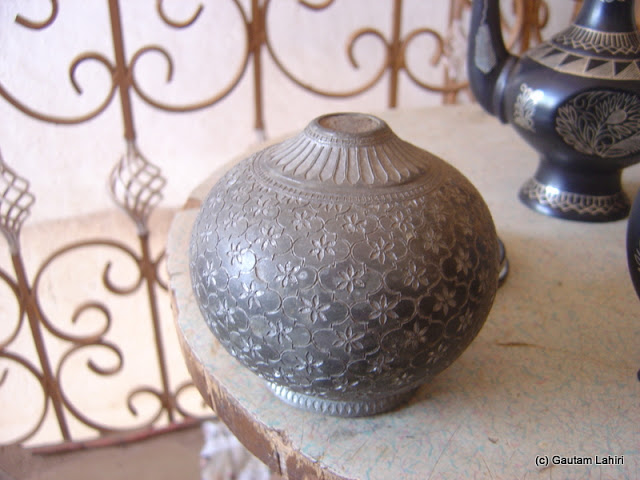 The base of a "Hukka" pot, finely sculpted and stands out before the Bidar fort's dust filled its indentations with a blackish glow by Gautam Lahiri
