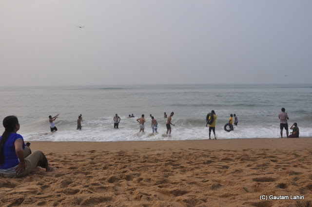 The playful bathers refuse to come out of the sea  at Puri, Bhubaneshwar, Odisha, India by Gautam Lahiri