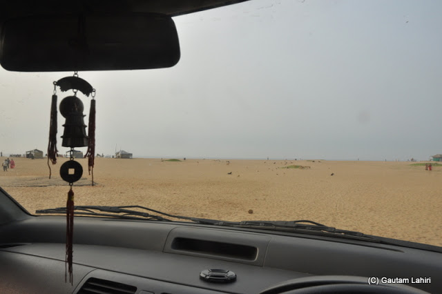 Through the tinted windscreen of the car, the wide expanse of the shimmering sand looked like a forbidden territory of quicksand  at Puri, Bhubaneshwar, Odisha, India by Gautam Lahiri