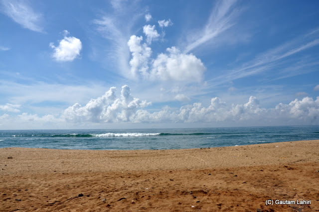 The gurgling Puri's sea green waters met the cloud studded azure sky  at Puri, Bhubaneshwar, Odisha, India by Gautam Lahiri