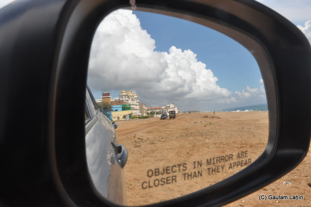 The sea looked formidable and gorgeous and was fast vanishing as the acres of sand swallowed her as we headed for our hotel  at Puri, Bhubaneshwar, Odisha, India by Gautam Lahiri